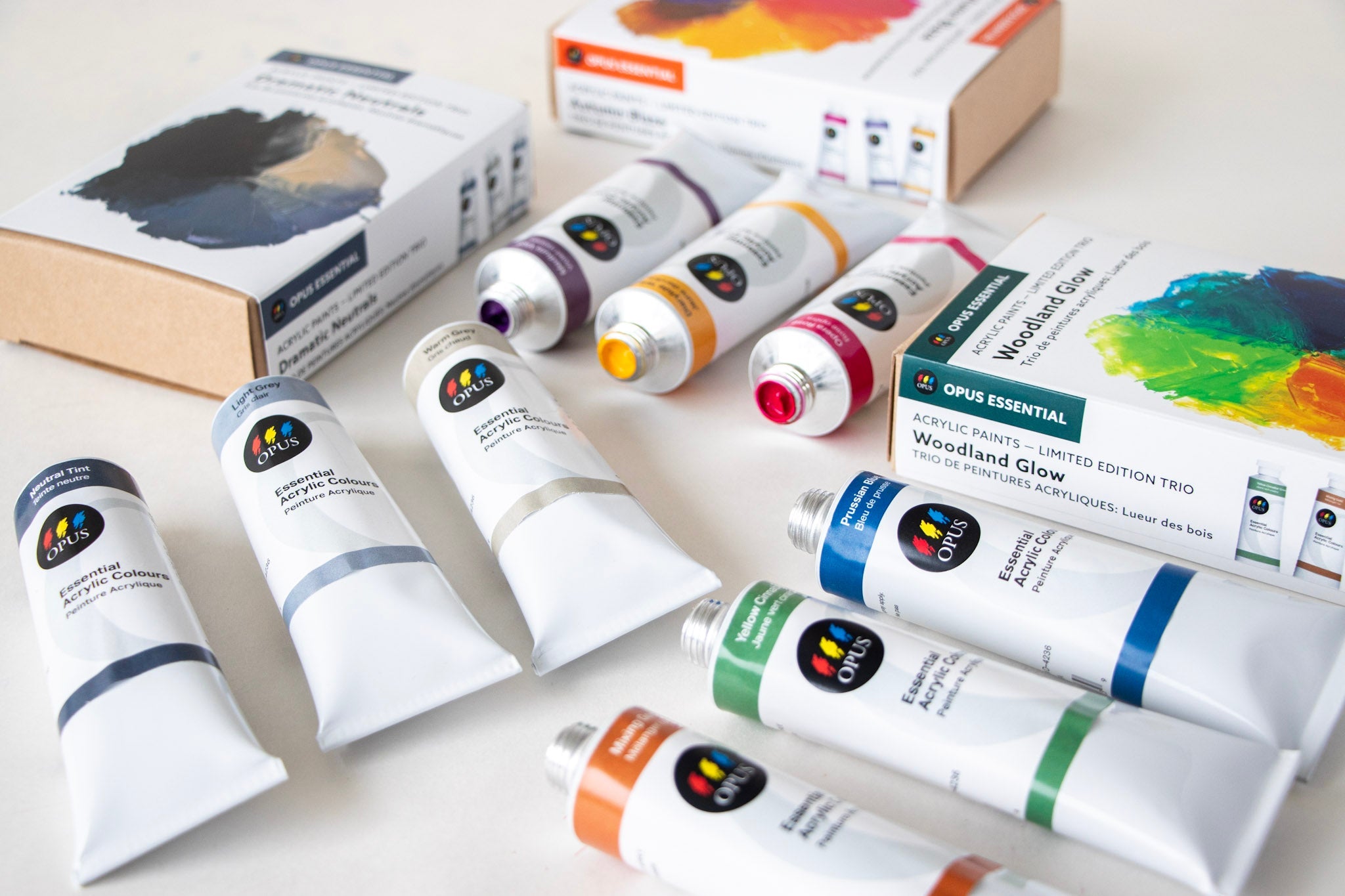 a photograph of the 3 new Opus Essential Acrylic Trio Sets with the tubes from each arranged outside of the boxes