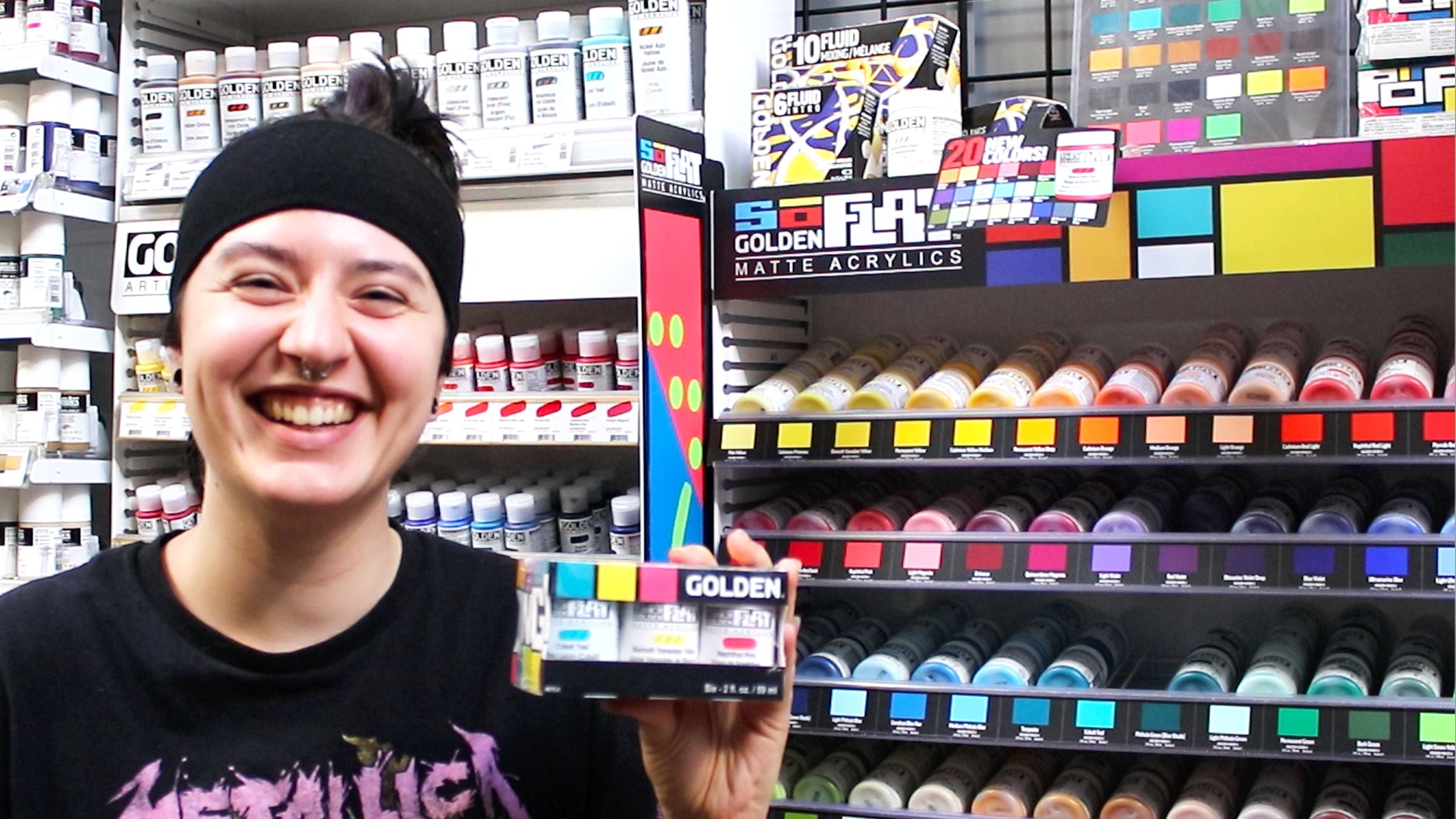 Opus Staff member holding GOLDEN SoFlat Acrylics set